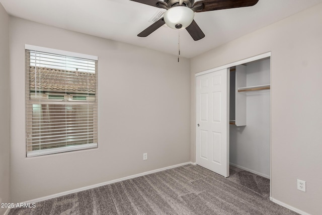 unfurnished bedroom with ceiling fan, a closet, and carpet floors