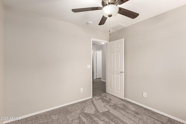 unfurnished room featuring ceiling fan and carpet floors