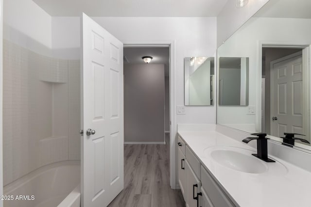 bathroom featuring vanity, shower / bath combination, and wood-type flooring