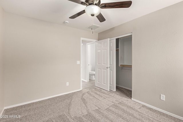 unfurnished bedroom with ceiling fan, light colored carpet, and a closet