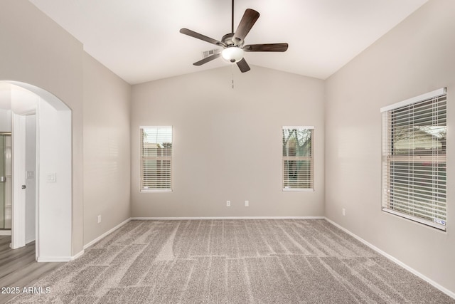 unfurnished room with ceiling fan, carpet flooring, and lofted ceiling