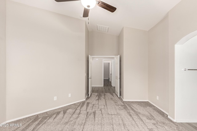 empty room featuring ceiling fan and light carpet