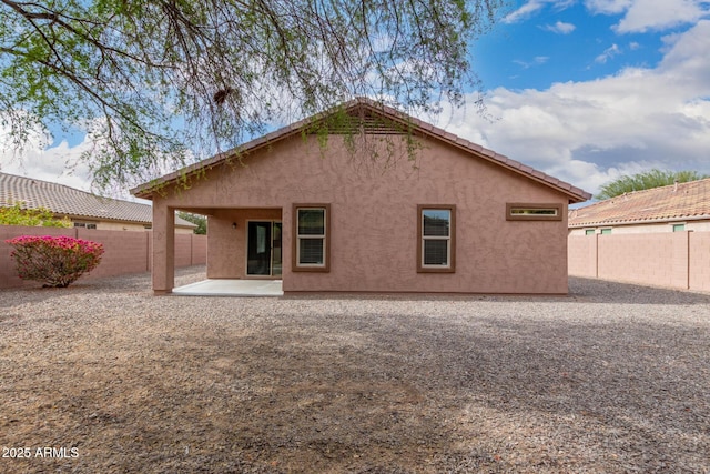 back of house with a patio area