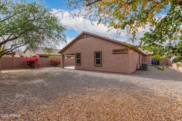 back of house featuring cooling unit and a patio