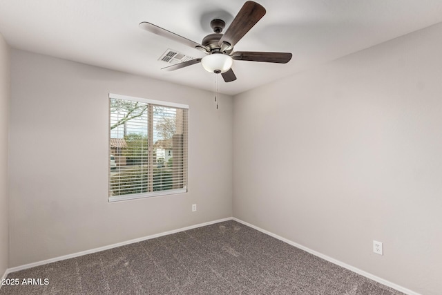 empty room featuring ceiling fan and carpet