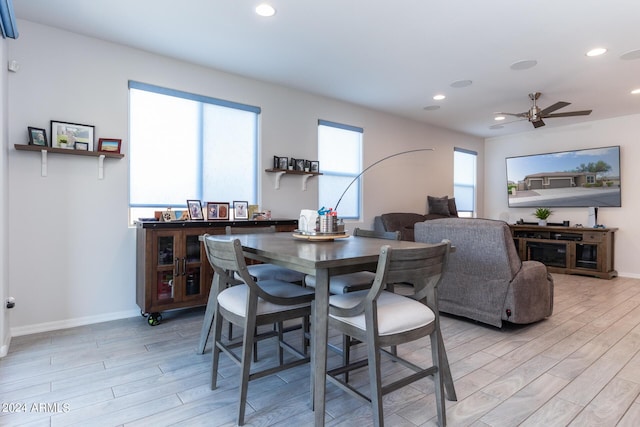 dining area with ceiling fan and light hardwood / wood-style flooring