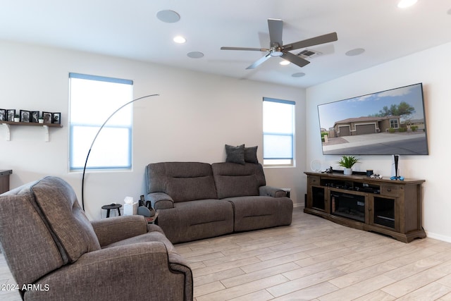 living room with ceiling fan and light wood-type flooring