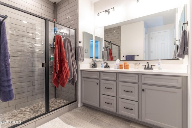 bathroom featuring vanity and an enclosed shower