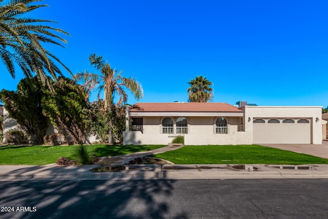 view of front of property featuring a garage and a front yard