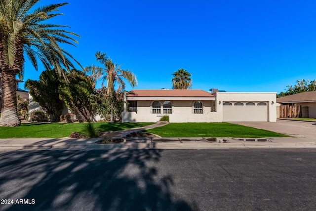 view of front of property featuring a front yard and a garage