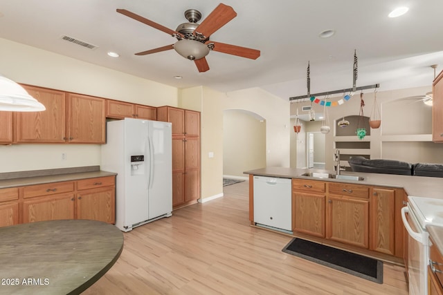 8256 W Bloomfield Rd, Peoria, AZ 85381 - kitchen with white appliances, a sink, ceiling fan, arched walkways, and light wood-type flooring