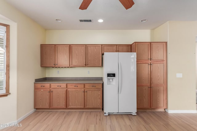 8256 W Bloomfield Rd, Peoria, AZ 85381 - kitchen featuring white refrigerator with ice dispenser, a ceiling fan, light wood-style floors, brown cabinetry, and baseboards