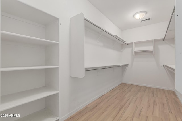 8256 W Bloomfield Rd, Peoria, AZ 85381 - walk in closet featuring wood finished floors