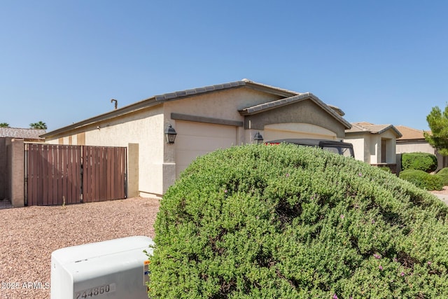 8256 W Bloomfield Rd, Peoria, AZ 85381 - view of property exterior with a garage and stucco siding