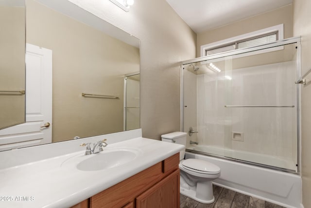 8256 W Bloomfield Rd, Peoria, AZ 85381 - full bath with toilet, wood finished floors, vanity, and enclosed tub / shower combo