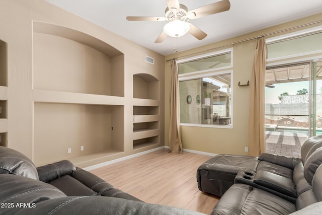 8256 W Bloomfield Rd, Peoria, AZ 85381 - living room with built in features, wood finished floors, a ceiling fan, and baseboards