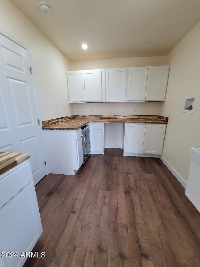 interior space featuring dark hardwood / wood-style floors, dishwasher, and white cabinets