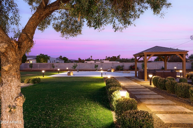 view of home's community with a lawn, outdoor lounge area, and a gazebo