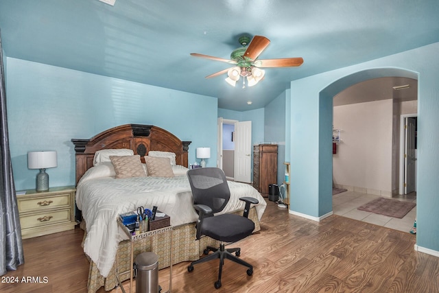 bedroom with ceiling fan and wood-type flooring