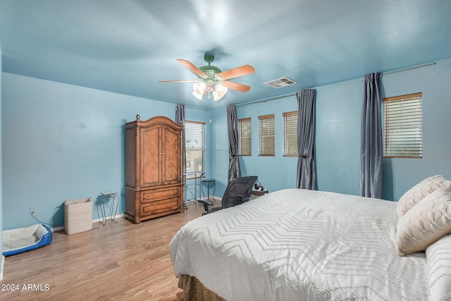 bedroom with ceiling fan and light wood-type flooring