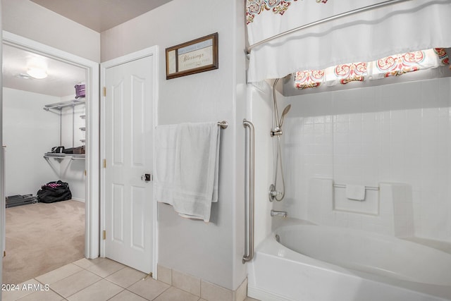 bathroom featuring washtub / shower combination and tile patterned floors