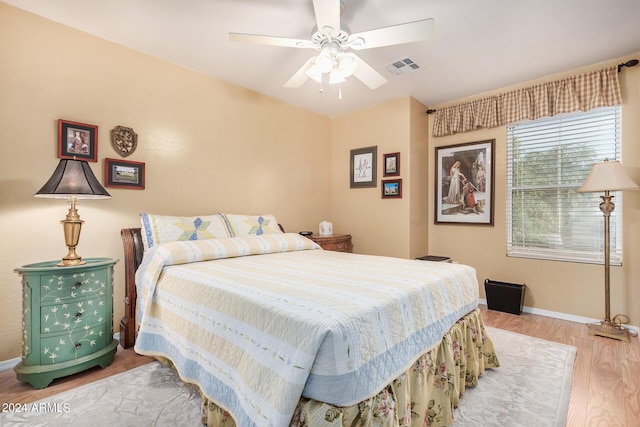 bedroom with ceiling fan and light hardwood / wood-style floors