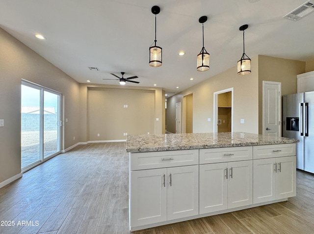 15422 S Sequoia Cir, Arizona City, AZ 85123 - kitchen with white cabinetry, stainless steel refrigerator with ice dispenser, visible vents, ceiling fan, and light wood finished floors