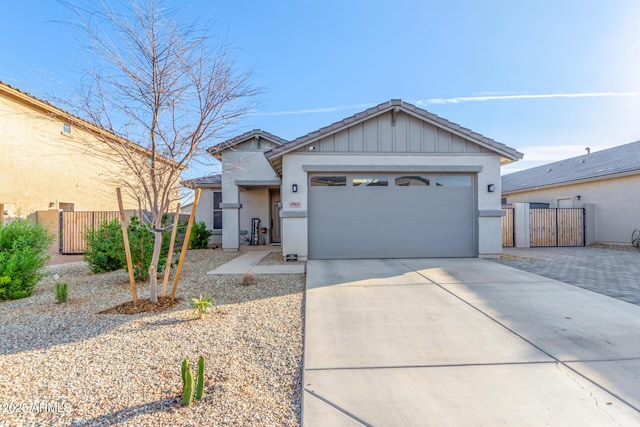 ranch-style home featuring driveway, a tiled roof, an attached garage, fence, and stucco siding