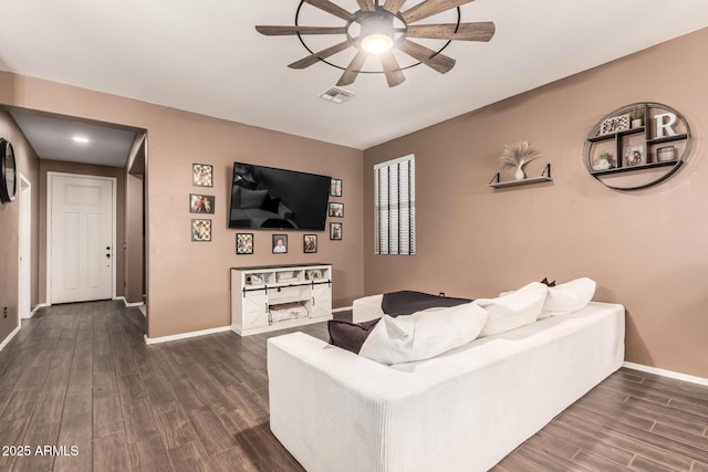 living room with dark wood-type flooring and ceiling fan