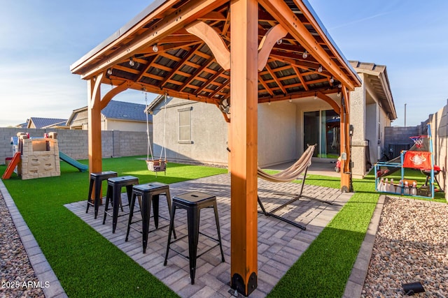 exterior space featuring a fenced backyard, a playground, and a gazebo