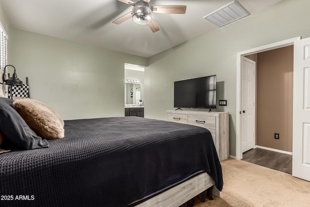 carpeted bedroom featuring ceiling fan and ensuite bath