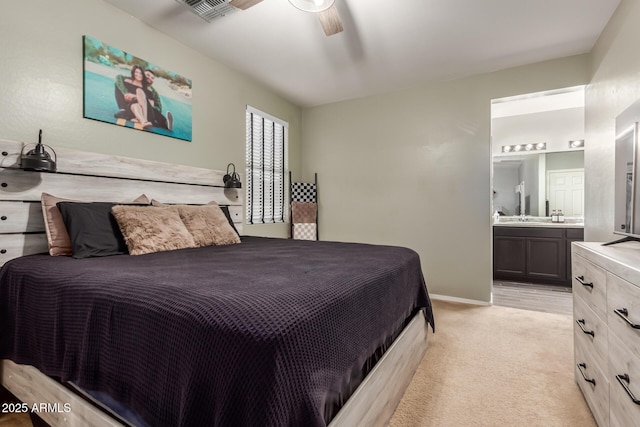 carpeted bedroom with connected bathroom and ceiling fan