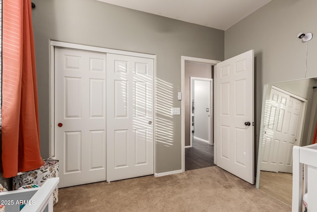 unfurnished bedroom with light carpet and a closet