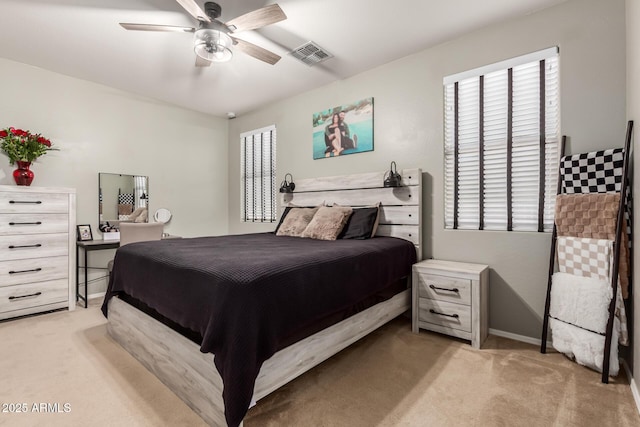 bedroom with light carpet, multiple windows, and ceiling fan