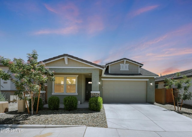 29339 N 135th Dr, Peoria, AZ 85383 - view of front of home with driveway, a garage, and stone siding