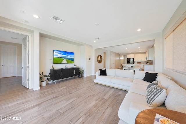 29339 N 135th Dr, Peoria, AZ 85383 - living room featuring light wood-style flooring, recessed lighting, and baseboards