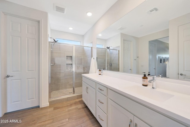 29339 N 135th Dr, Peoria, AZ 85383 - full bathroom featuring double vanity, a shower stall, wood finished floors, and recessed lighting