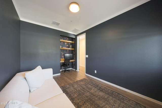 29339 N 135th Dr, Peoria, AZ 85383 - living area with wood finished floors, a desk, baseboards, and built in features