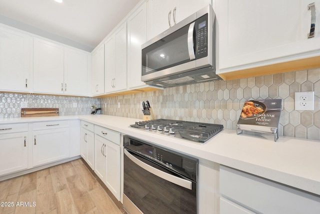 29339 N 135th Dr, Peoria, AZ 85383 - kitchen with appliances with stainless steel finishes, white cabinets, and light countertops