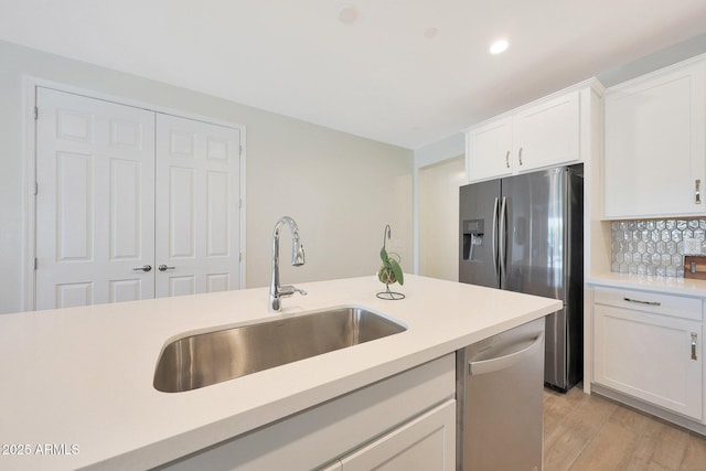 29339 N 135th Dr, Peoria, AZ 85383 - kitchen featuring stainless steel appliances, a sink, light countertops, white cabinetry, and light wood finished floors