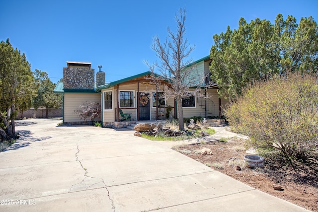 8455 Ridge Dr, Show Low, AZ 85901 - view of front of house with concrete driveway and a chimney