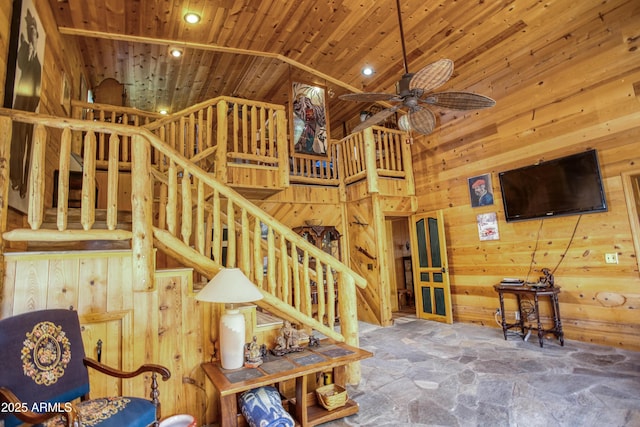 8455 Ridge Dr, Show Low, AZ 85901 - staircase with high vaulted ceiling, stone floors, wood ceiling, wood walls, and ceiling fan