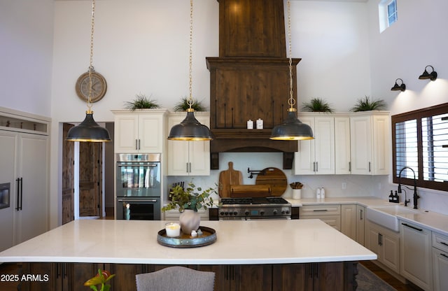 kitchen with premium appliances, plenty of natural light, a sink, and a kitchen island