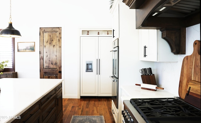 kitchen featuring dark wood finished floors, white cabinetry, wall chimney exhaust hood, range with gas cooktop, and light countertops