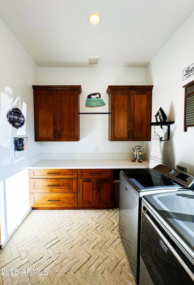 kitchen with washer and dryer, visible vents, and recessed lighting