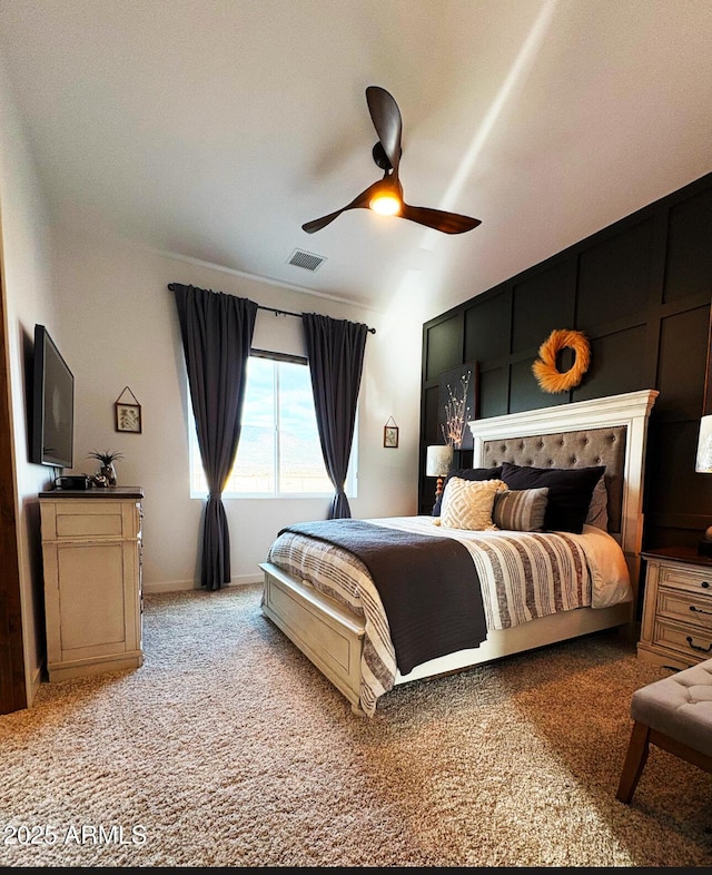 carpeted bedroom with a ceiling fan and visible vents