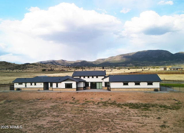 exterior space featuring fence and a mountain view