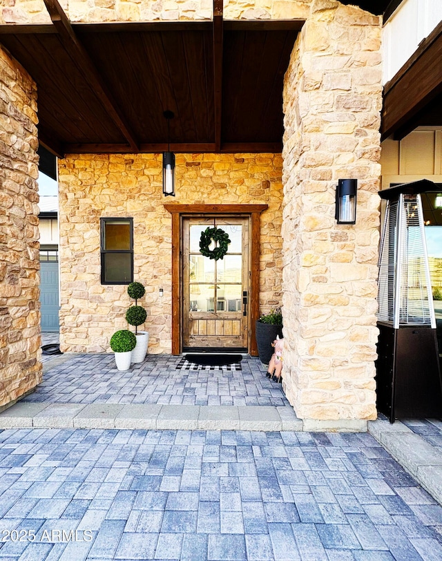 entrance to property featuring stone siding