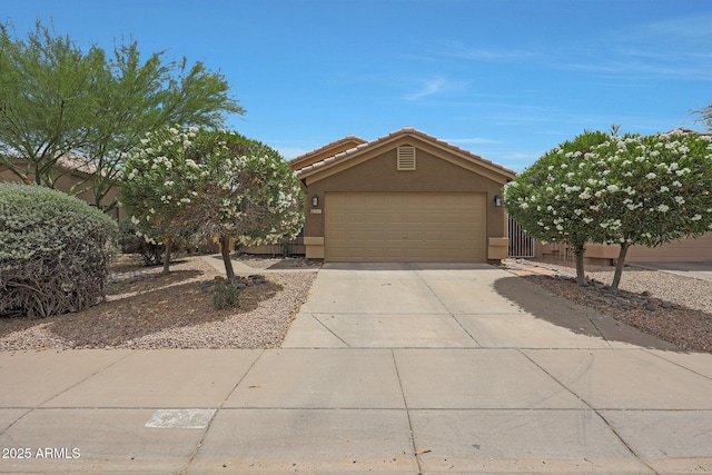 2627 E Gary Way, Phoenix, AZ 85042 - obstructed view of property featuring stucco siding, concrete driveway, and an attached garage