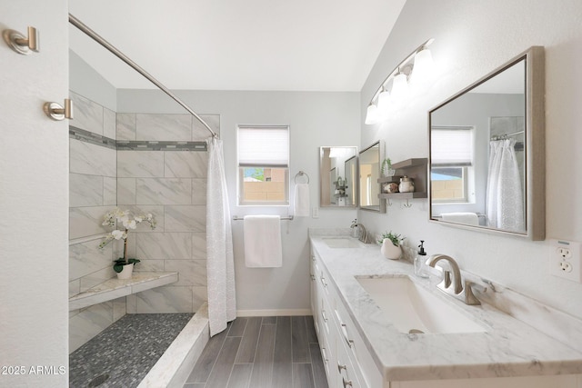 2627 E Gary Way, Phoenix, AZ 85042 - full bathroom with double vanity, baseboards, a tile shower, and wood tiled floors